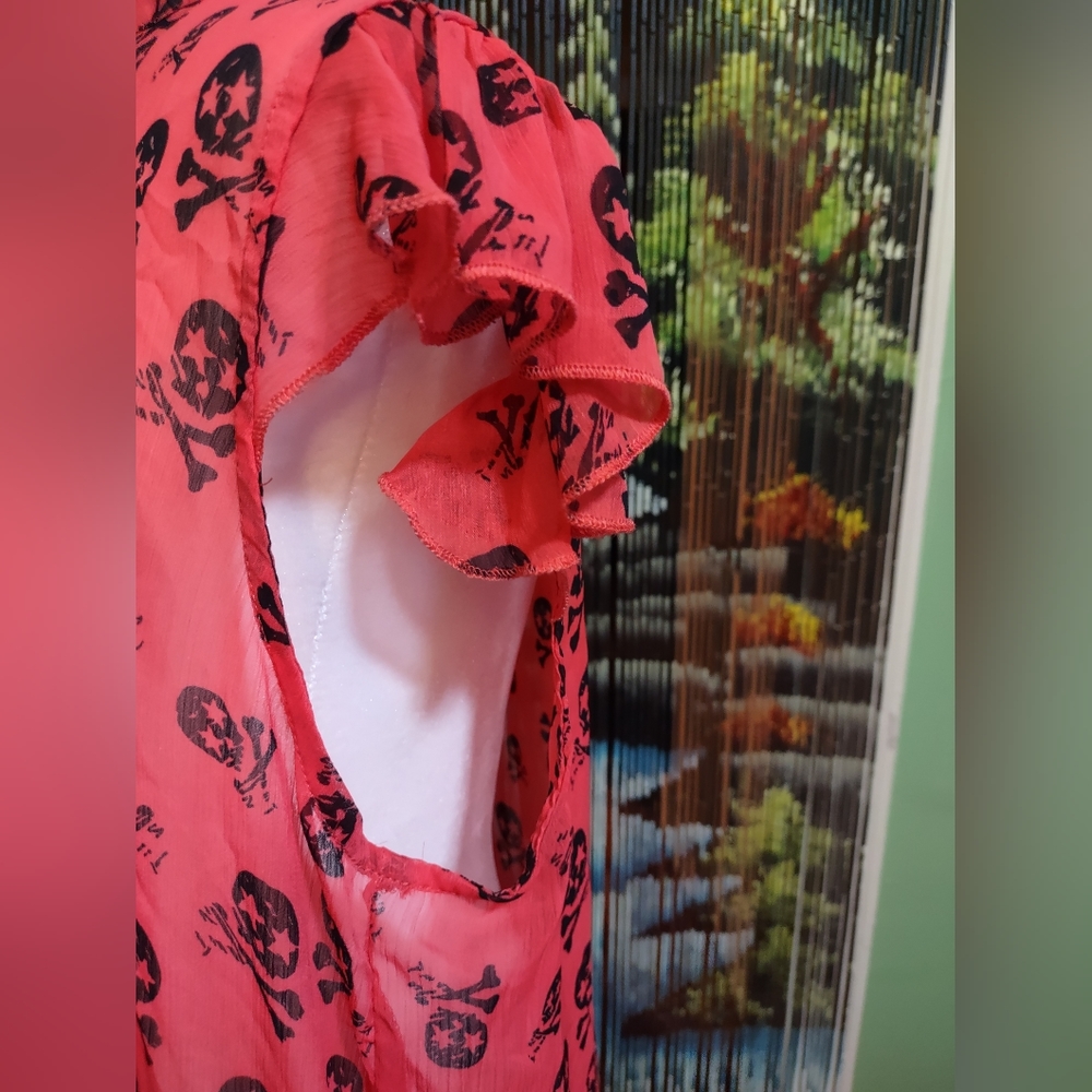 Orange skull and crossbones blouse. Size med/large